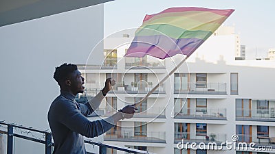 Black man waving rainbow flag. Sexual identity and equal treatmant concept Stock Photo
