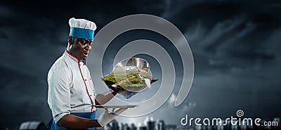 Black man wearing an apron and cooking in action. Mixed media Stock Photo