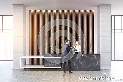 Black marble reception, wood blinds, people Stock Photo