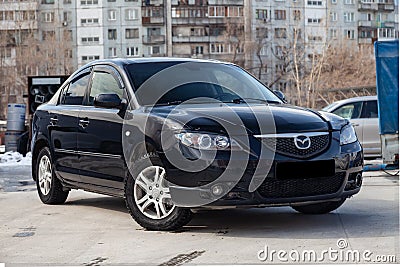 Black Mazda 3 2008 year front view with dark gray interior in excellent condition in a parking space among other cars Editorial Stock Photo