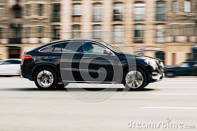 Black Mercedes Benz GLE coupe car moving on the street. Compliance with speed limits on road concept. Dynamic exterior image Editorial Stock Photo