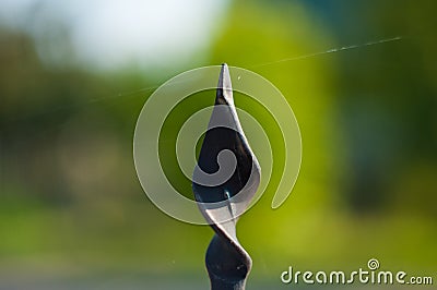 Black metal pin on a green background Stock Photo