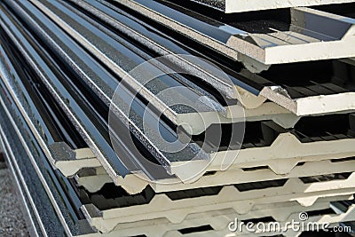 Black metal sheet roof with insulation attached under metal sheet. Stock Photo