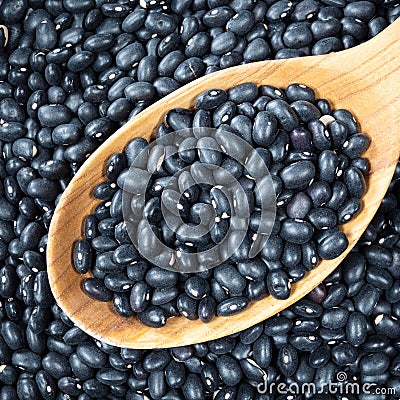 Black mexican beans in wooden spoon closeup Stock Photo