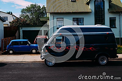 Black minivan with airbrushing in profile on a street in summer on a sunny day Stock Photo