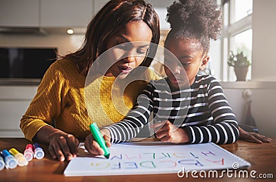 Black mother and child doing homework Stock Photo