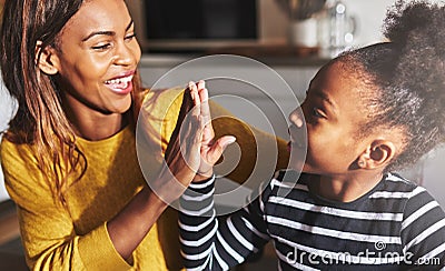 Black mother and child high five Stock Photo