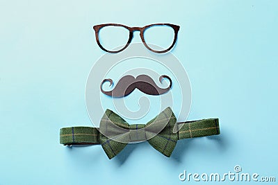 Black mustache, glasses and bow-tie on color background. Happy Father's Day celebration Stock Photo