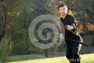 Black ninja with sword Stock Photo