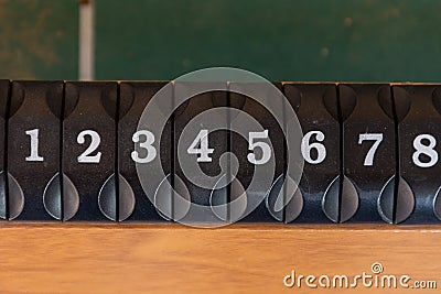 A black number slider on a table of the game of foosboll fusbol top view. Number sequence concept Stock Photo