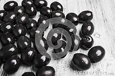 Black olives on a white wooden background Stock Photo