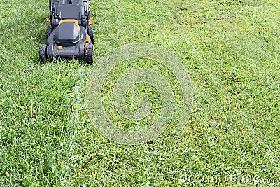 Black and Orange Lawn Mower and Fresh Cut Grass Stock Photo