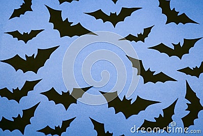 Black paper bats on a blue background. Stock Photo