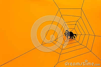 Black paper spider with web on yellow background. Halloween concept. Stock Photo