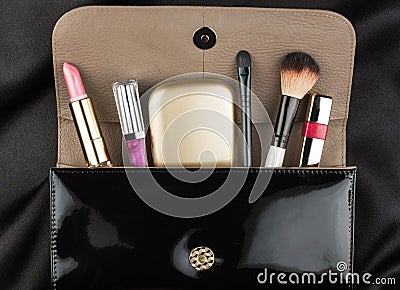 Black patent leather bag with cosmetics Stock Photo