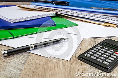 Black pen, calculator, colored folders for documents, envelopes, notebooks, stationery on the office desk. Workplace. Stock Photo
