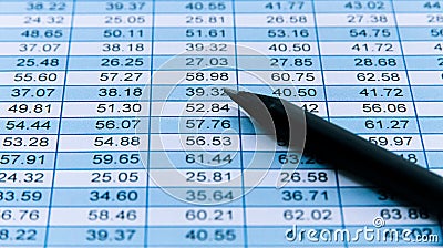 Black pencil macro over a financial spreadsheet numerical data table with columns detailing increasing numbers per column and row Stock Photo