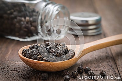 Black pepper on wooden spoon Stock Photo