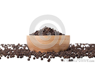 Black peppercorns in wooden bowl Stock Photo