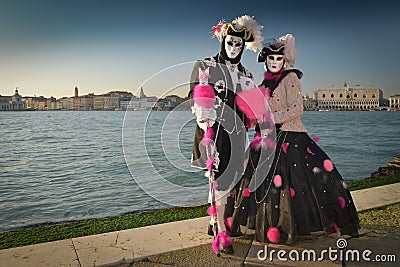 Black and pink costumed masked couple Editorial Stock Photo
