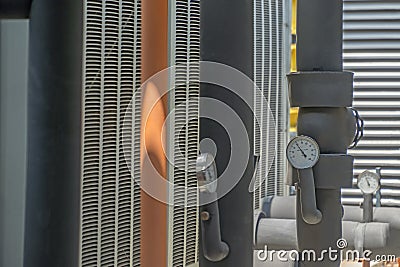 Black pipe are insulated with pressure gauge. Stock Photo