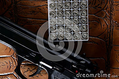 Black pistol handgun with bullet box Stock Photo