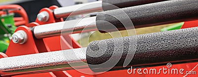 Black pistons or actuators in red pneumatic or hydraulic machine. Technology Stock Photo