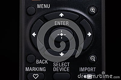 Black plastic remote control with menu and navigation buttons macro close up front view shot isolated on black Stock Photo