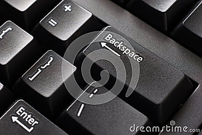 Black plastic standard English computer keyboard close up macro shot top side view backspace button Stock Photo