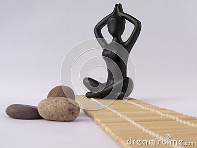 Black plastic women figure in lotus pose Stock Photo