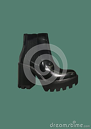 Black platform high-heel ankle boots isolated on green background. Women Casual Platform High Heel Boots Stock Photo