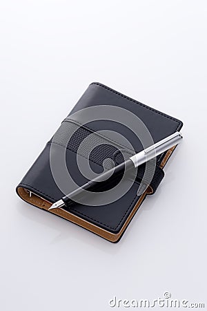 Black pocket diary and pen Stock Photo