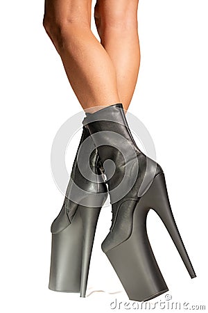 Black pole dance shoes. Woman legs in black high heels isolated on a white background. Striptease dancer. Vertical shot Stock Photo