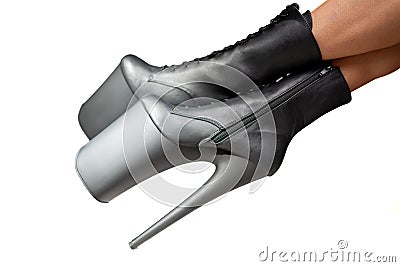 Black pole dance shoes. Woman legs in black high heels isolated on a white background. Striptease dancer. Close-up view. Stock Photo