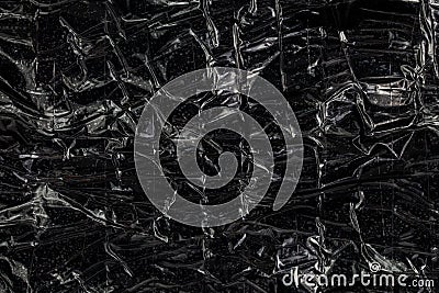 Black polyethilene film enforced by sticky tape flat smuggle package closeup texture Stock Photo
