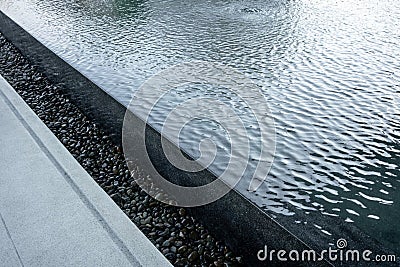 Black pool with overflow water system decorated with black grave Stock Photo