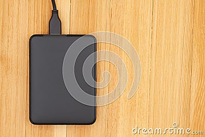 Black portable hard drive with a cable Stock Photo