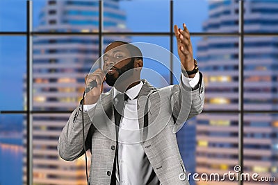 Black preacher speaking into microphone. Stock Photo