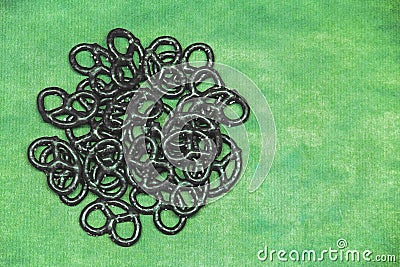 Black pretzel on a green background copy space Stock Photo