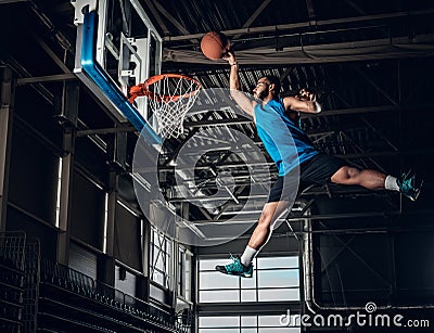 Black basketball player in action in a basketball court. Stock Photo