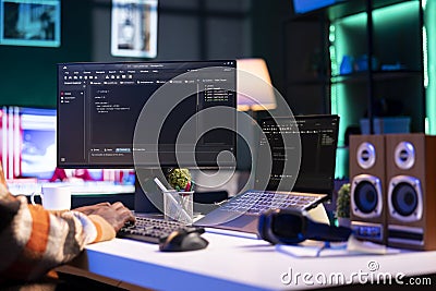 Black programmer remotely working in home office writing code on computer Stock Photo