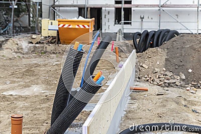 Black PVC flexible corrugated plastic insulation pipes tubing of electrical cables wire at undeground installation. New Stock Photo