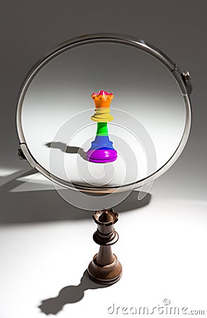 A black queen is looking in a mirror to see herself as queen covered with a rainbow flag. Stock Photo