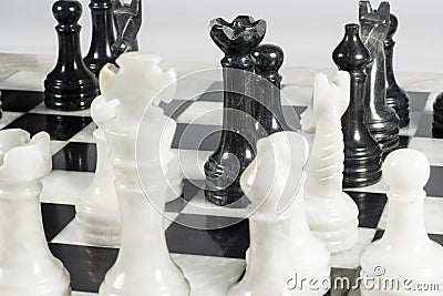 Black queen makes suicide check. Queen's gambit. Marble chessboard Stock Photo