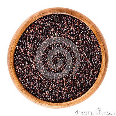 Black quinoa seeds in wooden bowl over white Stock Photo