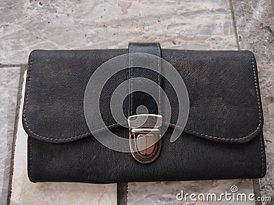 A black rectangular wallet that is dusty but doesn& x27;t lose its function Stock Photo