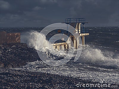 Black Rock diving rock at storm and high tide covered by a giant splash of water. Salthill, Galway city, Ireland.Night time Stock Photo