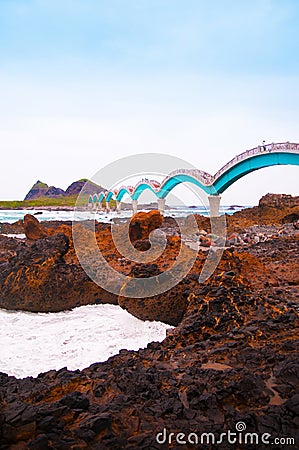 Black rocks beach and Sanxiantai bridge, Taitung, Taiwan. Stock Photo