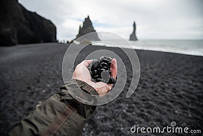 Black rocks on hand from black sand beach Reynisfjara Vik ,Iceland. Stock Photo