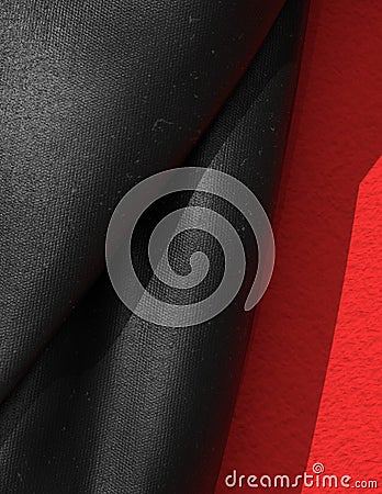 Black Rubberized Fabric Close Up on Red. Stock Photo